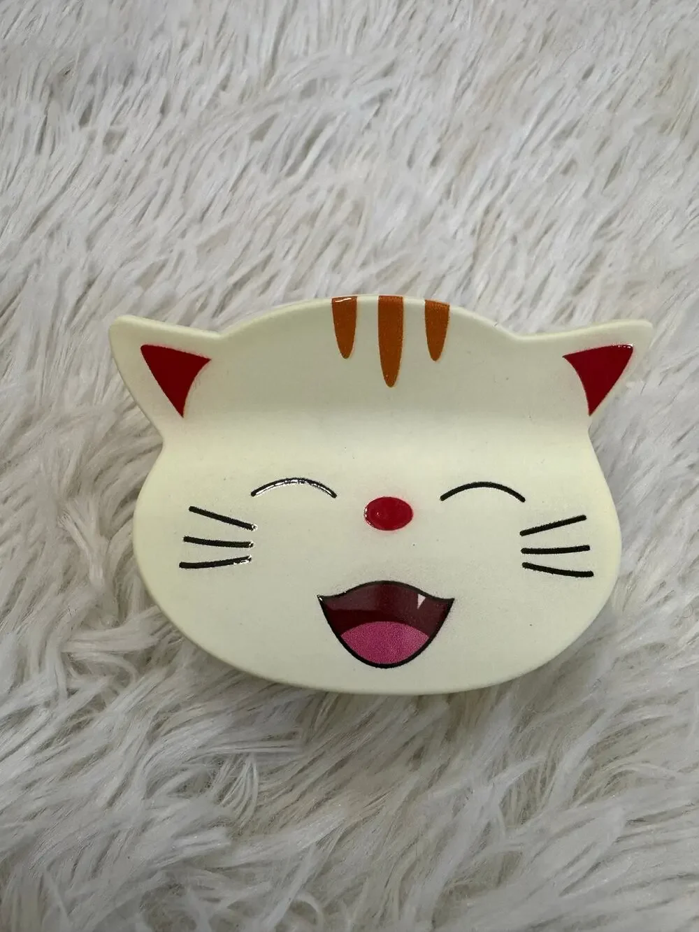 Large yellow cat hair clip claw with orange stripes on ears and forehead